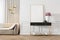 Modern classic white interior with dresser, console, sofa, furniture, lamp, flower, gifts, frame, picture.