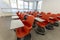 Modern classroom interior, with white board and movable tables and chairs. Theater style setting