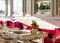 Modern classy Italian restaurant dining room with white tables and red velvet cushions