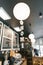 Modern coffee shop, interior, bar counter, focus on white round paper lamp and the word home in wooden letters. Home cafe concept