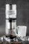 Modern Cold brew drip tower coffee maker on dark stone background