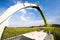 Modern combine harvester unloading green corn