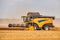 Modern Combine Harvester in a Wheat Field. Agricultural Seasonal Work