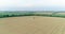 Modern combine harvester working on the wheat crop. Aerial view.