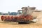 Modern combine harvests a wheat field