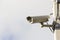 Modern compact video surveillance camera on support post in public areas on white background general plan