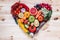 Modern composition of fresh healthy vegetables and fruits on the wooden table in the kitchen. Vegetarian vegan background.