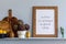 Modern composition on the kitchen interior with mock up photo frame, wooden cutting board, herbs, vegetables.