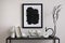 Modern composition of minimalistic interior with mock up poster frame. Black commode, vase with dried flowers, sculptures and