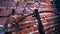 A modern compound crossbow handgun on the red brick wall background. Old weapon concept.