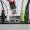 Modern convenient multi-port usb charger for devices. Close-up of inserted multi-colored cables in a power outlet. Macro