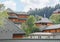 Modern cottages on slope of forested mountains