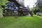 Modern countryside wooden house with big mirrored windows.