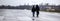 Modern couple walking trough a rainy cityscape