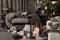 Modern cozy interior in gray shades with an armchair in front of fireplace and decorated Christmas tree.