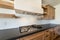 Modern craftsman kitchen counter with gas cooktop with griddle and custom vent hood insert