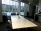 modern creative co working space workplaces with black chair,white long table in interior