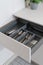 Modern cupboard with drawer for storage cutlery at kitchen