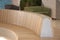 Modern curved shaped brown wooden bench indoor