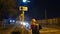 Modern cute teen girl waiting green light on a traffic-light at the road.