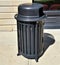 Modern cylindrical black trash receptacle