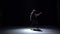 Modern dancer girl in dark dress continue dancing contemporary on black, shadow, slow motion