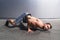 Modern dancer poses on floor on gray background