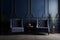 Modern dark home interior in dark navy blue colors with two empty armchairs, neural network generated photorealistic