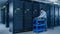 In the Modern Data Center: IT Technician Working with Server Racks, on a Pushcart Various Equipmen