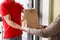 Modern delivery of any order. Girl takes package from hands of courier