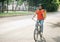 Modern delivery in city. Young man in helmet with bag rides on bicycle