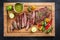 Modern design barbecue dry aged wagyu bavette de flanchet steak with chili and chimichurri sauce on a wooden cutting board