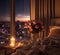 modern design bedroom,big windows on night city ,flowers and candles cozy room,buildings blurred light