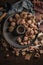 Modern design black ceramic bowl with walnuts, hazelnuts, almonds, chestnut hedgehogs on dark countertop and background. Autumn