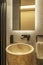 Modern design toilet with brown marble sink, highly textured wall