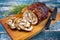 Modern design traditional Italian Porchetta arrotolata pork meat sliced and as piece with herbs on a design wooden board