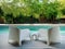 Modern design white plastic chairs at swimming pool side and outdoor garden, comfortable veranda decorated, wooden deck, back yard