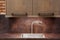 Modern designer chrome water tap over stainless steel kitchen sink