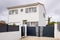 Modern detached storey house with metal gate grey fence on suburb street home