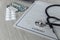 Modern doctor`s office desk. Stethoscope and healthcare contract on wooden table close-up