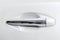 The modern door handle of a white car. Car detailing. Car exterior details. Closeup Car door handle. Car equipment concept.