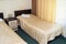 Modern double room with two single beds, bedside table, towels and table lamp, cozy inexpensive room for travelers, good service