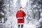 Modern dressed Santa Claus travelling with a backpack throught winter the forest, ai generated