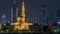 Modern Dubai city skyline timelapse with Rashid Al Hadeeth Mosque at night with illuminated skyscrapers over water