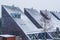 Modern dutch pointy rooftops covered in snow, Modern neighborhood during winter season, snowy cold weather in the Netherlands