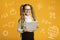 Modern education with gadgets. Schoolgirl holding tablet, around abstract symbols of education