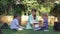 Modern education methods, classmate pupils boy and girl with tutor female read schoolbook and chat during lesson on lawn