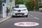 Modern electric car plugged in charging on the street station. New energy vehicles, environment friendly alternative energy for