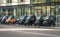 Modern electric microcars or quadricycles parked in a row in the streets of Amsterdam