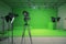 Modern empty green photo studio with old style movie camera